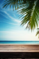 Wooden table surface with sea view and palm leaves. Calm sea and sky at beach background