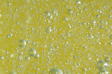 Bubbles in the water on a yellow background. Macro.
