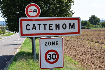 town sign of Cattenom, no overtaking, speed limit 30
