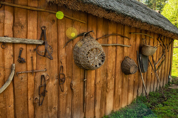 Ancient tools of labor and everyday life on the wall of a wooden barn. culture and traditions of Europe. Ukraine.