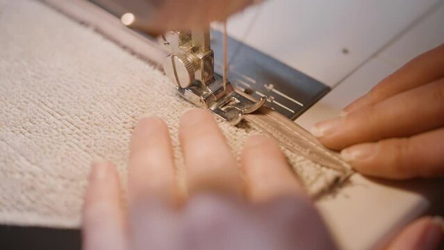 sewing machine and woman's hands