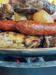 Parrillada serving of meat and potatoes in Chile