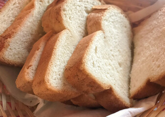 Slices of white bread with bokeh in a basket