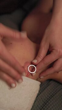Emotional video displays the importance of rings in relationships a baby gets an earring, a couple exchanges wedding rings, and a woman enjoys a relaxing massage with a ring in her ear