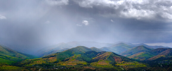 Rainstorm Over Mountains Hills in Springtime Spring Rains - 795476040