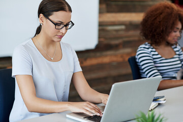 Business woman, laptop and typing in office for company project, writing email and working online. Female person, technology or pc at desk job for internet website, planning or research collaboration