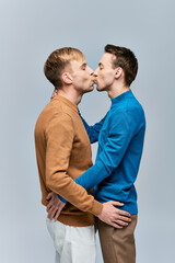 Two men in casual attires kissing each other affectionately.