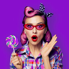 Purple head excited very surprised woman in red glasses with lollipop. Pinup girl with wide opened mouth, eyes. Isolated against bright color background. Square composition.