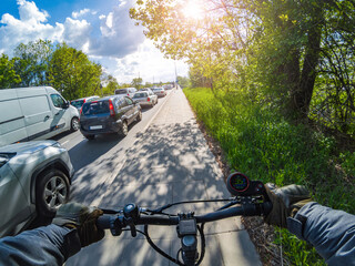 Riding an electric scooter in sunny weather. Overtaking Traffic: The Fastest Mode of Transportation in the City.. First-person view.