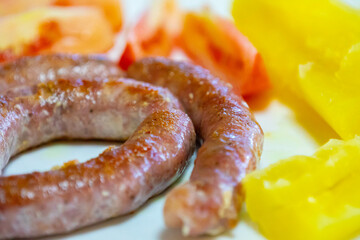 Traditional rustic Brazilian food, sausage with cassava and tomatoes