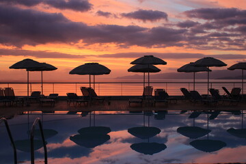 Fabulous sunrise by the sea by the pool early in the morning in Elounda on the island of Crete.
