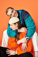 Obraz premium Two men sitting atop each other in a loving embrace.
