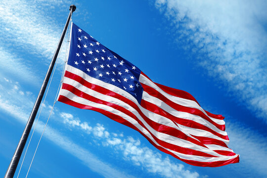 American flag on blue sky with beautiful clouds