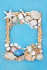 Pearl and sea shell decorative abstract gold picture frame design on mottled blue background. Natural nature border design with large collection of shells.