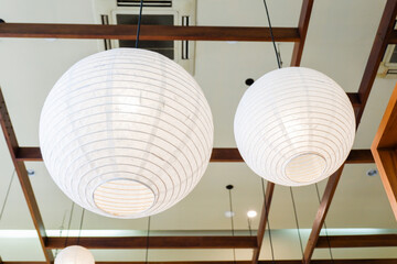 Traditional asian white paper lantern on the ceiling in living room at home,detail of white...