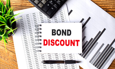 BOND DISCOUNT text on notebook on chart with calculator and pen