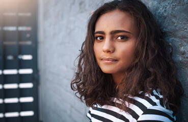 Young girl, portrait and face with fashion on a wall for casual clothing or outdoor style of gen z....