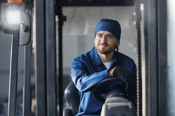 Portrait young man worker driver of forklift on industry factory, Warehouse of food plant
