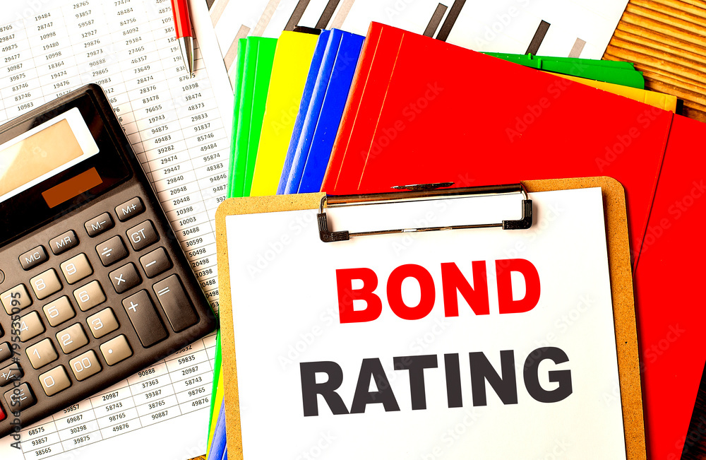 Poster bond rating text on clipboard with calculator and color folder