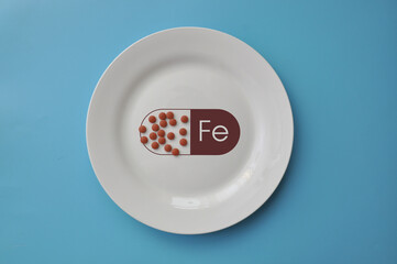 The mineral "iron" in tablets on a white plate. Iron deficiency in the body