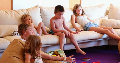 Children at living room sofa in front of TV play room kids and friends together