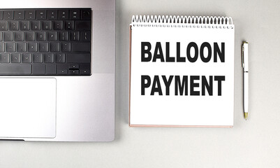 BALLOON PAYMENT text on notebook with laptop and pen
