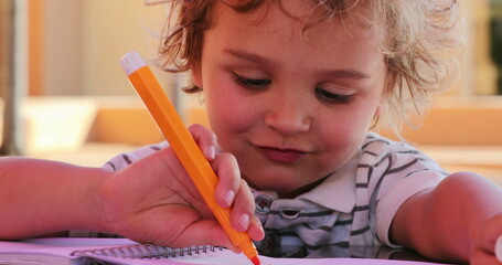 Little boy holding color pen drawing