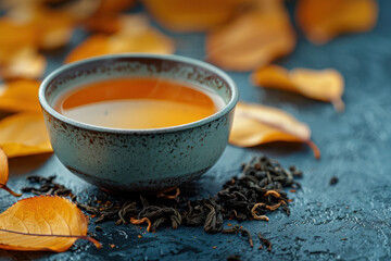 Steaming cup of tea surrounded by leaves - 795541297