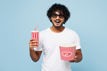 Young happy Indian man he wear white t-shirt casual clothes 3d glasses watch movie film hold bucket...