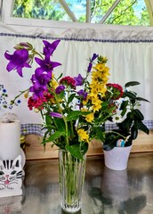 Garden Variety in a Vase: A colorful array of garden flowers, including purple bellflowers...