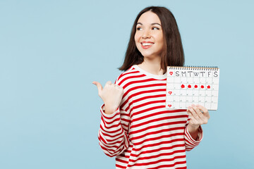 Young happy woman wear red casual clothes hold female periods pms calendar checking menstruation...