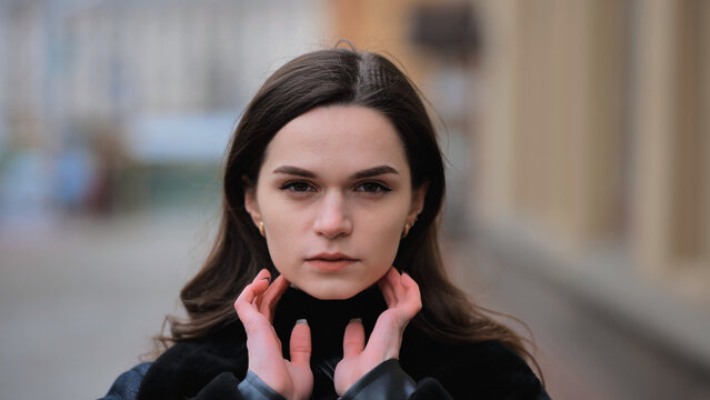 Sensitive portrait of a brunette girl on a cloudy spring day