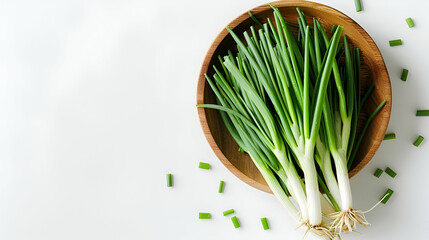 Photography of Green onion in wooden bowl isolated on the white background. Top view. Flat lay. realistic daylight