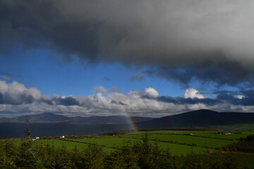 Naklejka na ściany i meble View of rainbow over tne mountains. Coppanagh Hill, Co. Kilkenny, Ireland