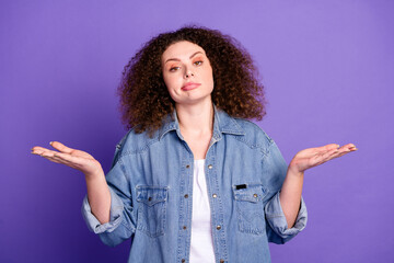 Portrait of pretty young woman shrug shoulders wear denim shirt isolated on purple color background