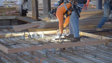 Construction worker welding steel and metal on a construction site creating sparks and arc flash