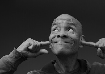 deaf man suffering from deafness and hearing loss on grey background with people stock photo	