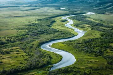 Aerial view of a meandering river through a pristine wilderness, emphasizing the importance of water conservation