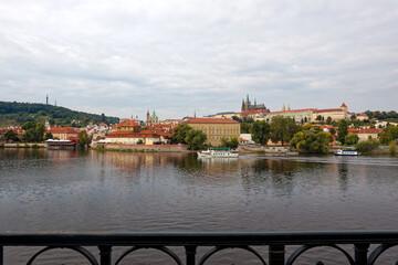 Scenic view of Moldova River with famous Charles Bridge of Czech City of Prague with castle and...