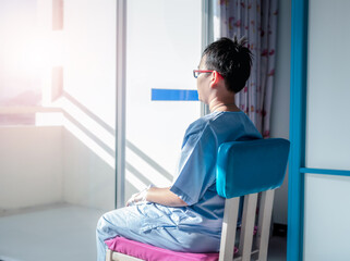 Back view of  kid in intensive care unit or icu.Covid19 coronavirus. toddler boy wearing IV tube looking out window in hospital - Powered by Adobe