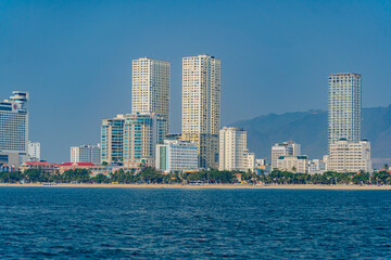 Fototapeta premium The city is from a distance from the sea. Nha Trang city in Vietnam. View of the city from the sea.