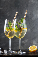 Refreshing Hugo Spritz Cocktail with Elderflower Liqueur, Mint and Lemon on Dark Background
