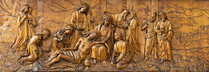MILAN, ITALY - MARCH 5, 2024: The carved relief  Deposition (Pieta - cross way) in the church...