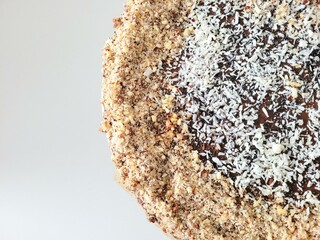 Protein cake with nuts powder, chocolate and coconut flakes.