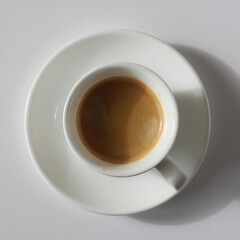 Espresso Shot with Crema Foam Closeup. Fresh Coffee Top View on White Background.