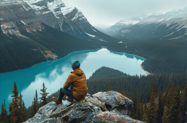 Person Sitting on Mountain Overlooking Lake