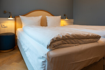 Large double bed bedside tables and lamps in the hotel room. Hotel furniture.