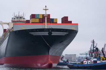 MARITIME TRANSPORT - A container ship maneuvers in a seaport
