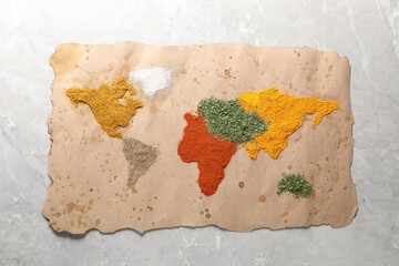 World map of different spices on light grey marble table, top view