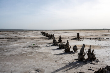 Fototapeta na wymiar landscape of the Baskunchak salt lake with infrastructure for salt extraction on a sunny spring day